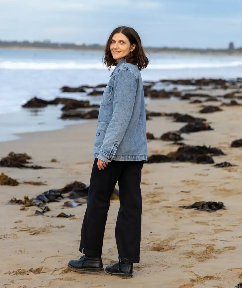 Sara standing on a beach